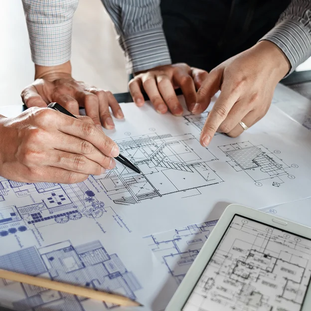 Mains d'architectes révisant des plans de construction imprimés et sur tablette à l'Ile de Ré en Charente-Maritime 17